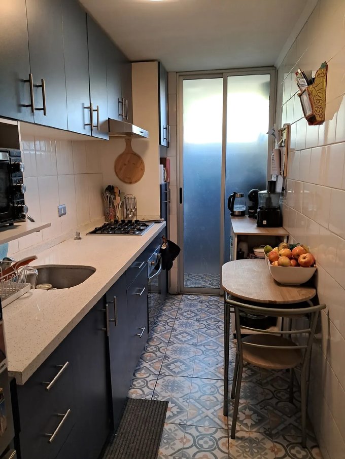 Cocina remodelada con encimera, horno empotrado y refrigerad